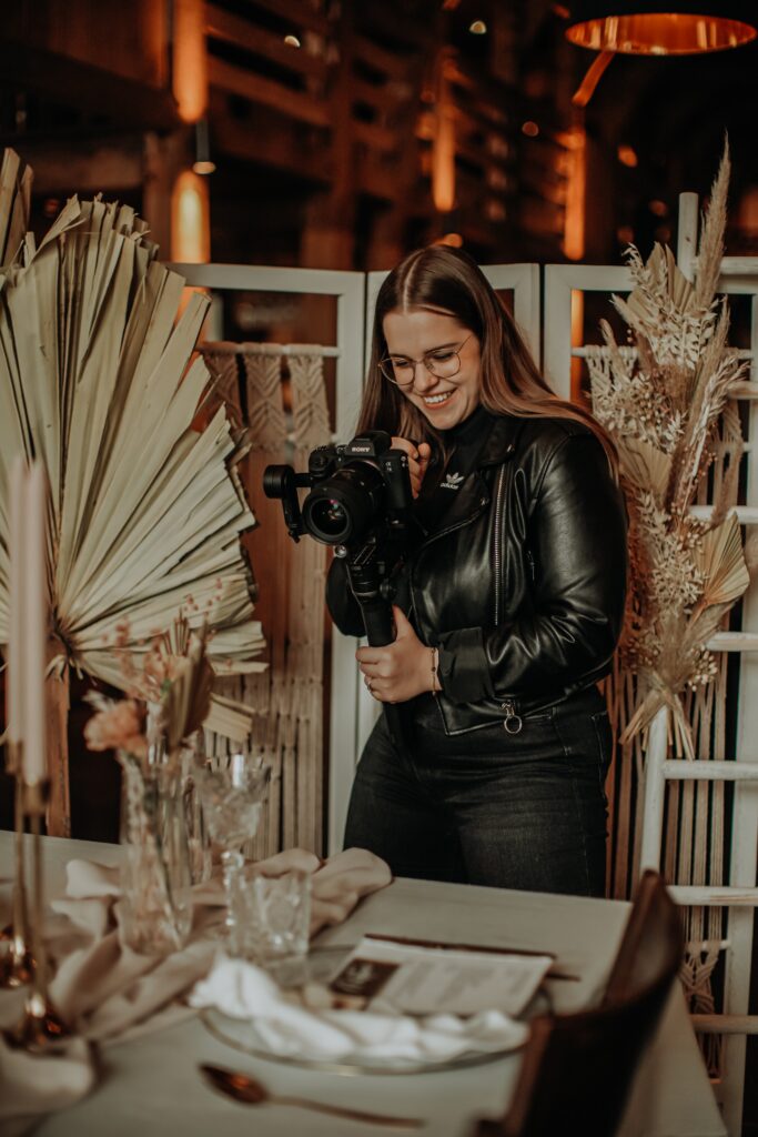 Photographer taking photos at a wedding reception. 