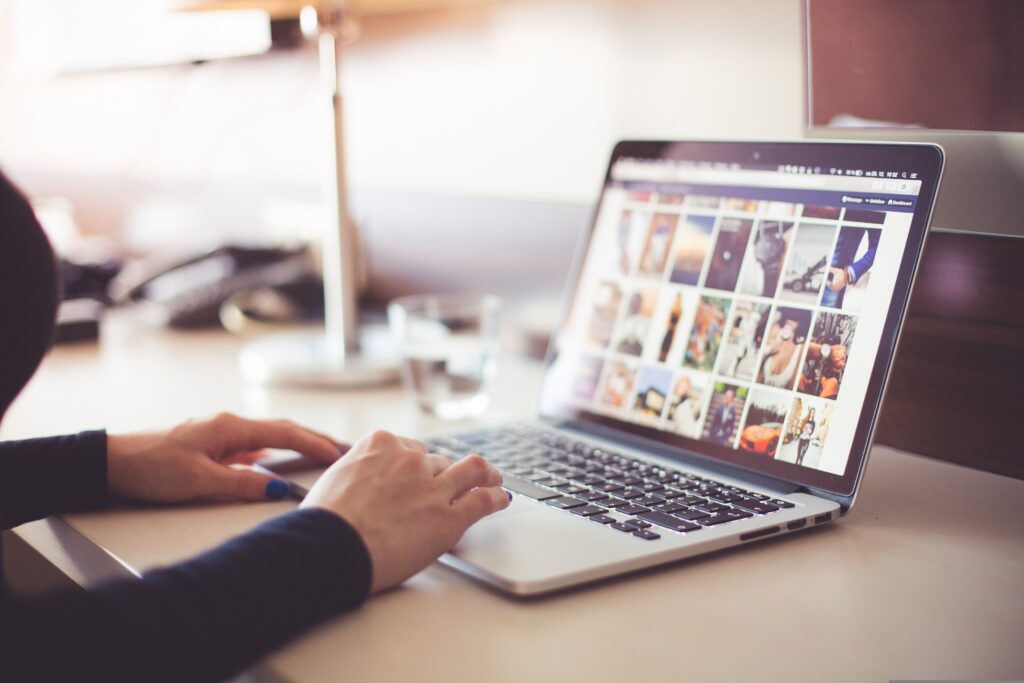 A woman working on a computer and editing photos. 