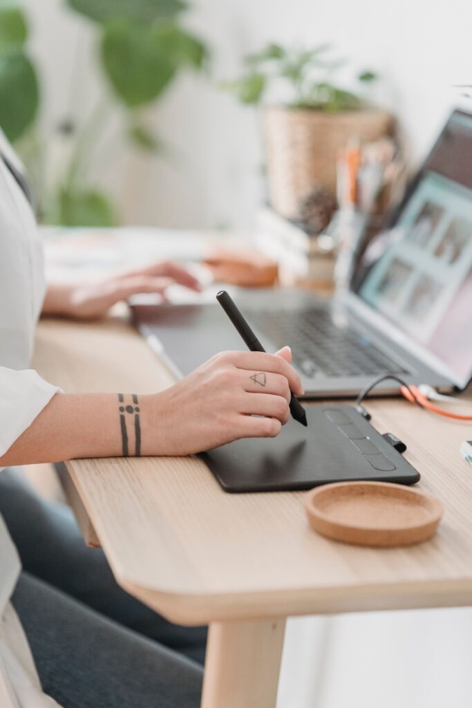 Website designer sitting at the table working on a website
