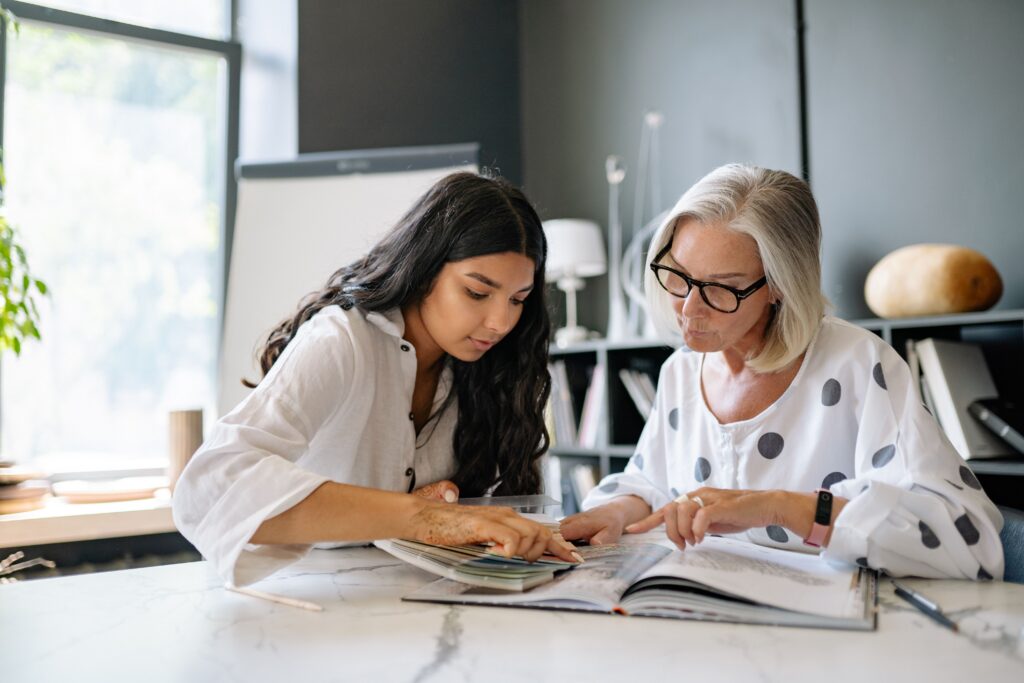 Two women discussing branding for a client in an office. 
