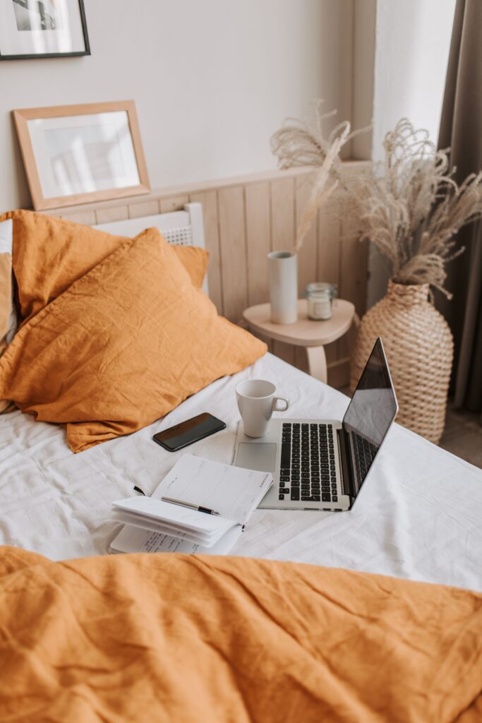 Computer on bed while a web designer and SEO expert works.